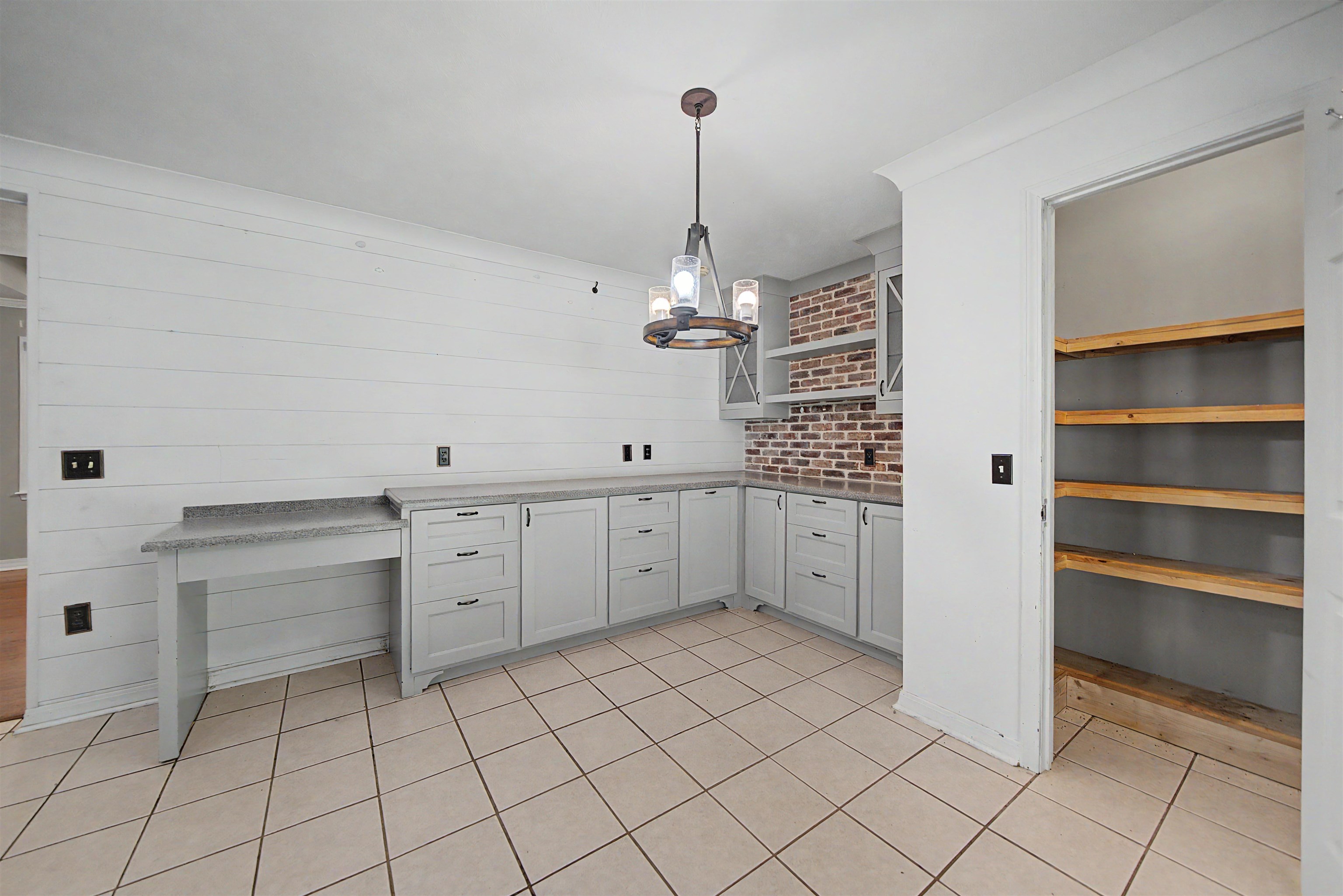 436 Skyline Road Selmer, TN 38375 - Photo 33 of 40 Kitchen area featuring light gray cabinetry, a built-in desk, and granite-look countertops