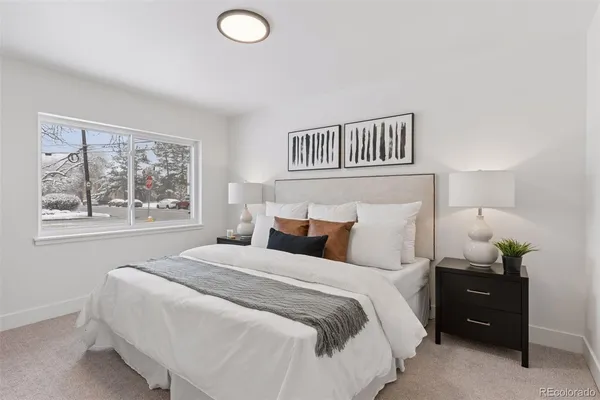 a bedroom with a bed and window