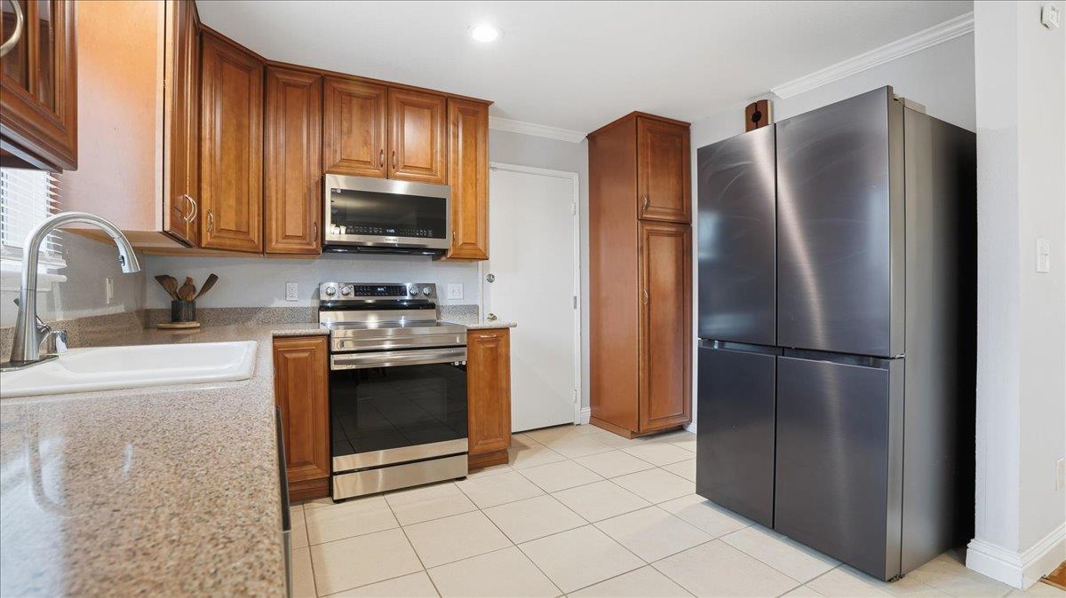 5701 Chipping Way Citrus Heights, CA 95621 - Photo 15 of 41 a kitchen with stainless steel appliances granite countertop a refrigerator stove and sink