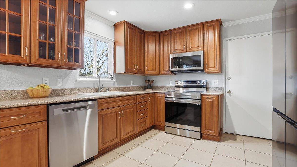5701 Chipping Way Citrus Heights, CA 95621 - Photo 16 of 41 a kitchen with stainless steel appliances granite countertop a stove a sink and a microwave