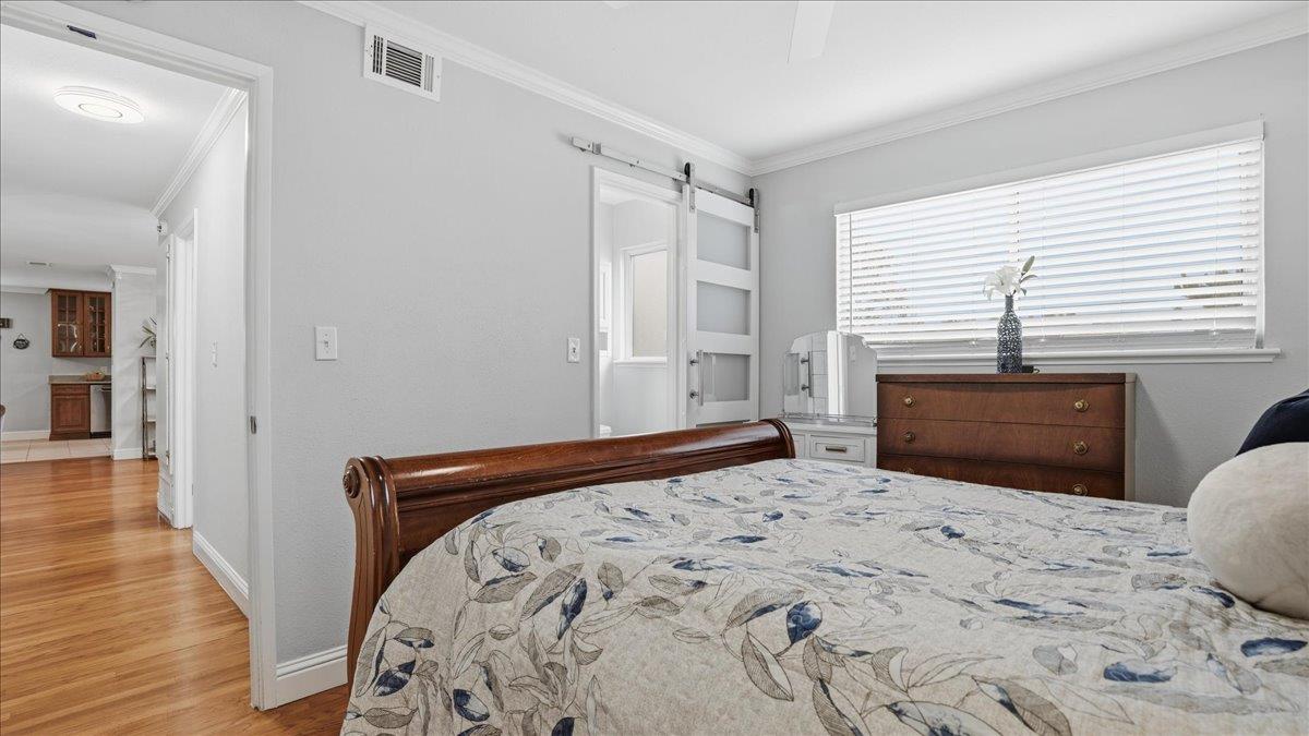 5701 Chipping Way Citrus Heights, CA 95621 - Photo 27 of 41 a bedroom with a bed and wooden floor