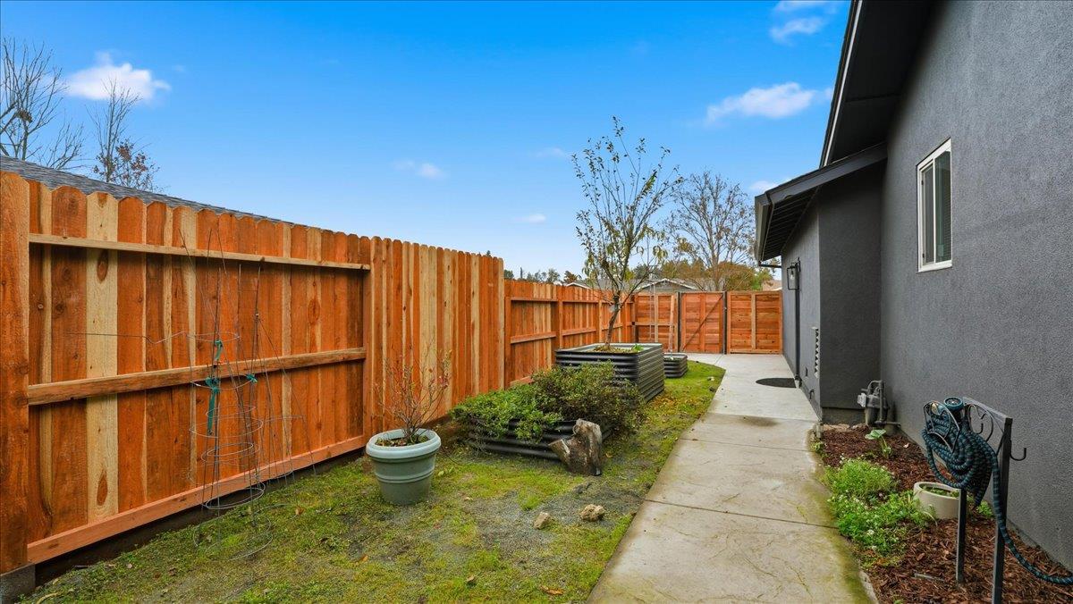 5701 Chipping Way Citrus Heights, CA 95621 - Photo 34 of 41 a backyard of a house with lawn chairs plants and wooden fence