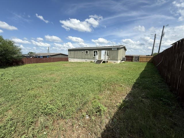 393 Duchess Pass Kyle, TX 78640 - Photo 12 of 14 A spacious backyard with mature green grass perfect for outdoor living and recreation.