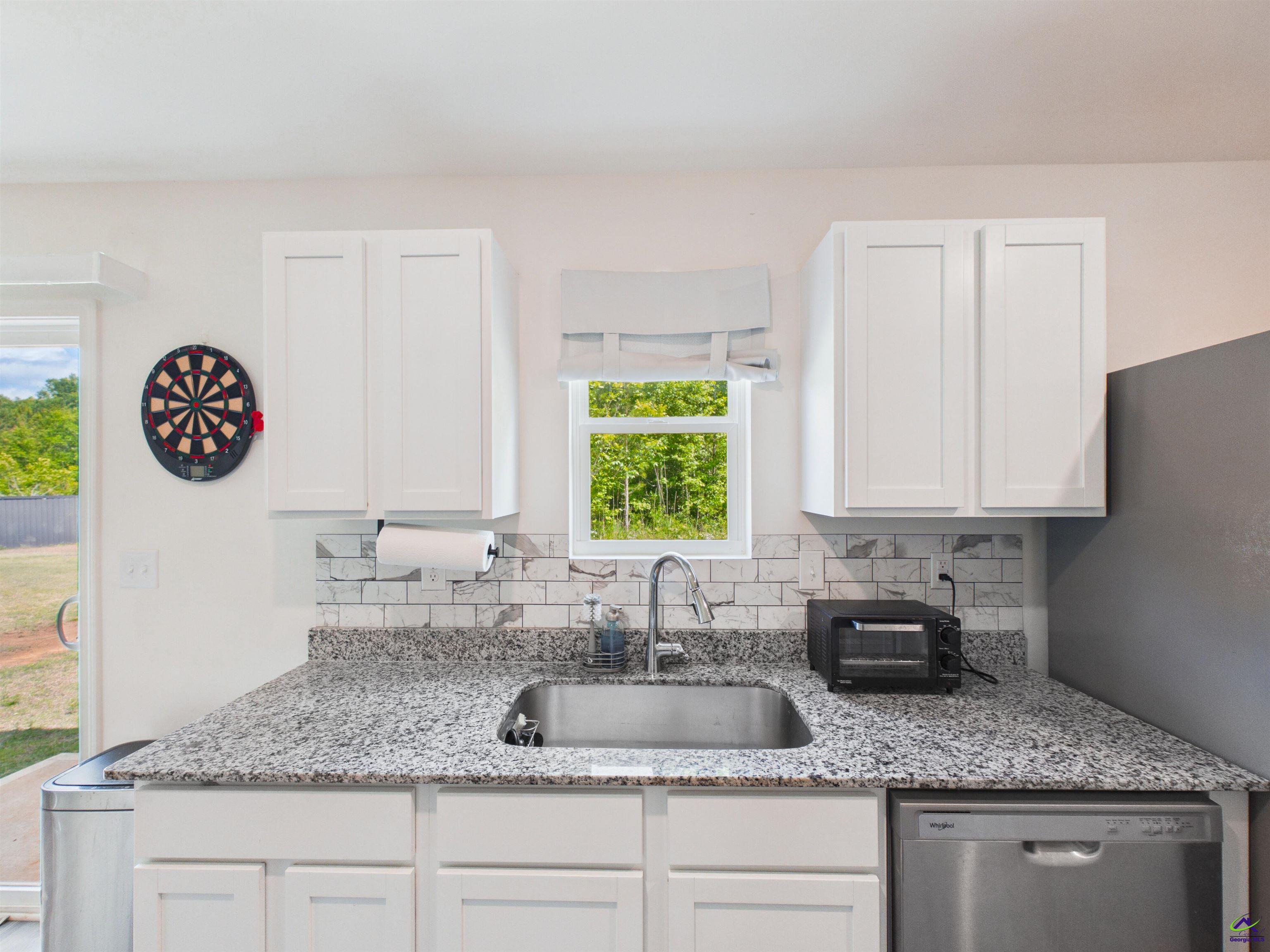116 Jamie Court Fort Valley, GA 31030 - Photo 6 of 19 a kitchen with granite countertop a sink a stove and cabinets