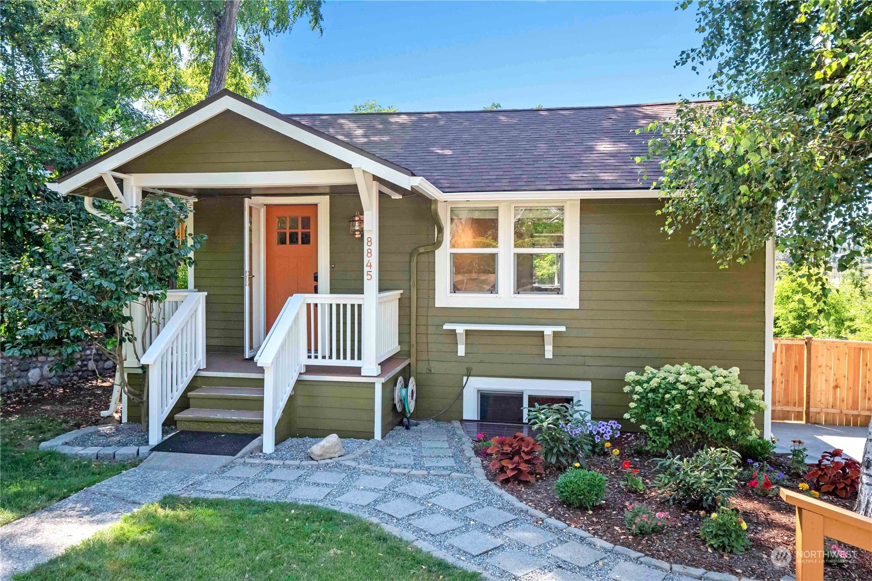 8845 24th Avenue Southwest Seattle, WA 98106 - Photo 1 of 22 a front view of a house with a garden