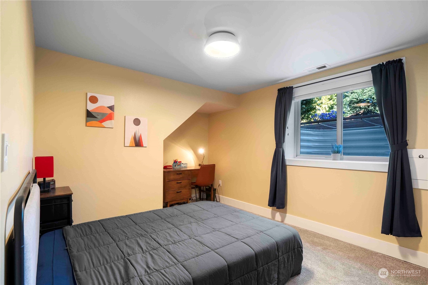 8845 24th Avenue Southwest Seattle, WA 98106 - Photo 14 of 22 a bedroom with a bed and a large window