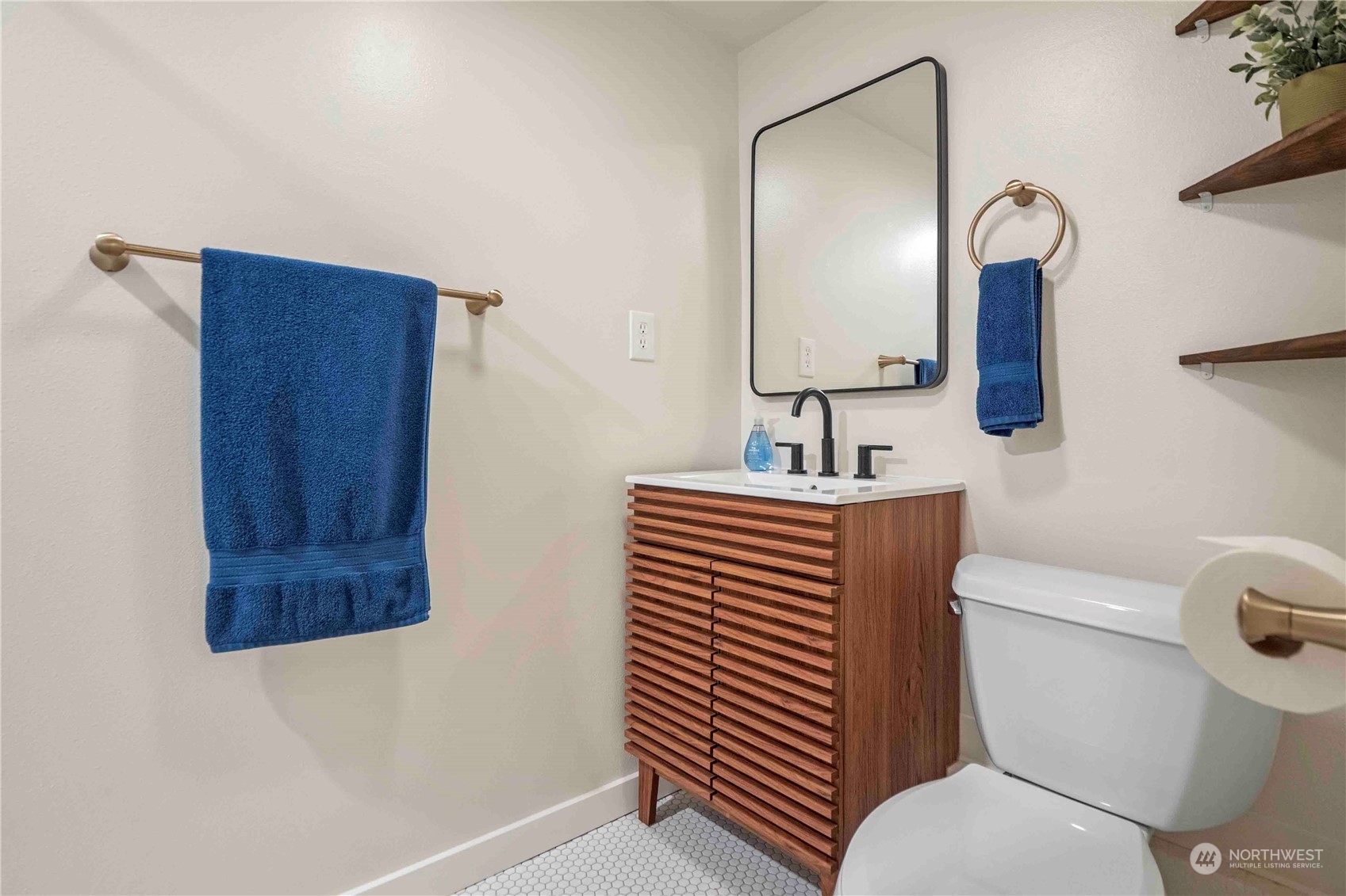 8845 24th Avenue Southwest Seattle, WA 98106 - Photo 16 of 22 a bathroom with a toilet a sink and mirror