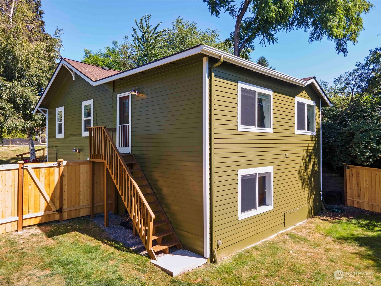 8845 24th Avenue Southwest Seattle, WA 98106 - Photo 18 of 22 a view of an house with backyard and trees