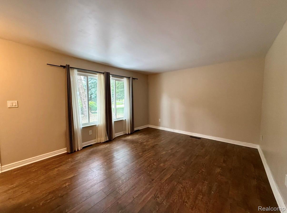 2360 Oklahoma Avenue Rochester, MI 48309 - Photo 11 of 36 Spacious room featuring rich wood-finish flooring, neutral wall tones, and white trim