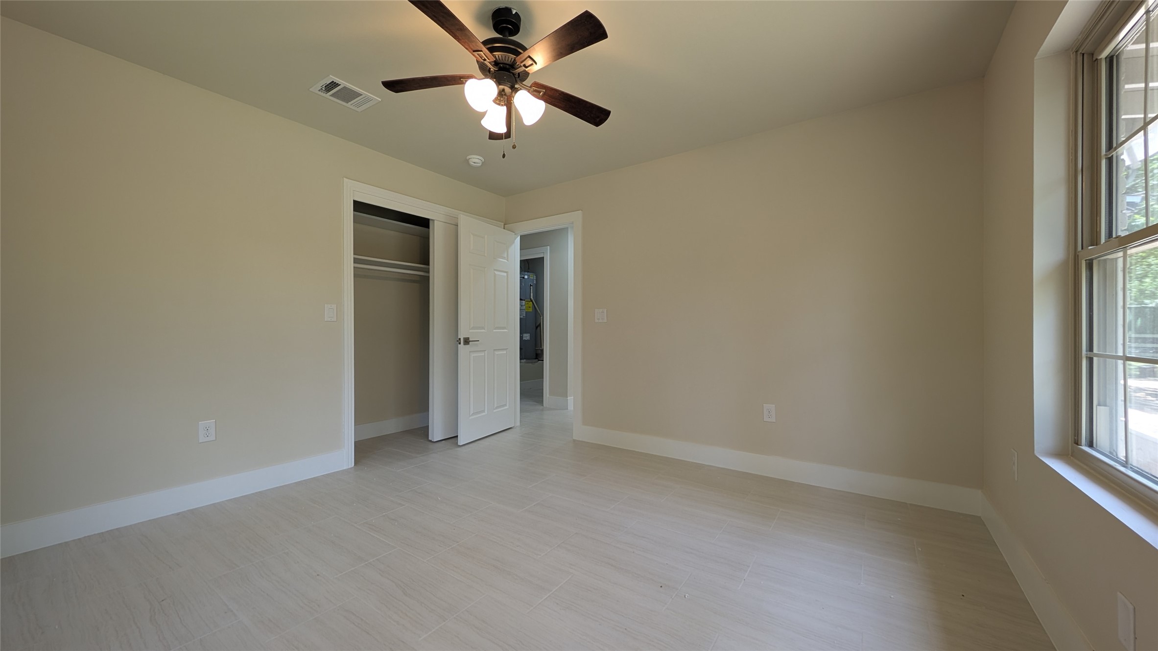 11811 Sleepy Hollow Road Manchaca, TX 78652 - Photo 20 of 31 an empty room with chandelier fan and windows