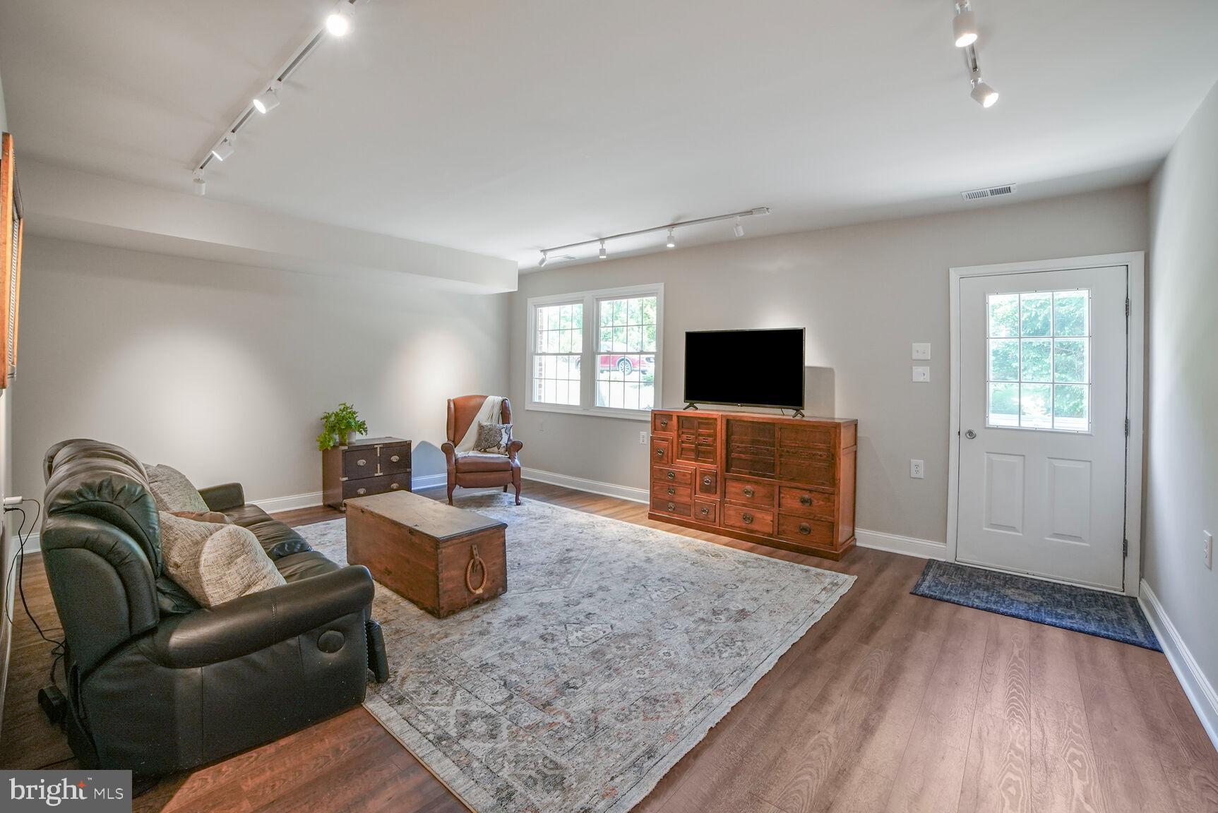 7549 Cherry Tree Drive Fulton, MD 20759 - Photo 23 of 64 a living room with furniture and a flat screen tv