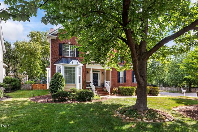 a front view of a house with yard and green space