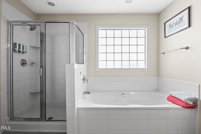 a bathroom with a bathtub and shower