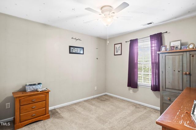 a view of room with cabinet and ceiling fan