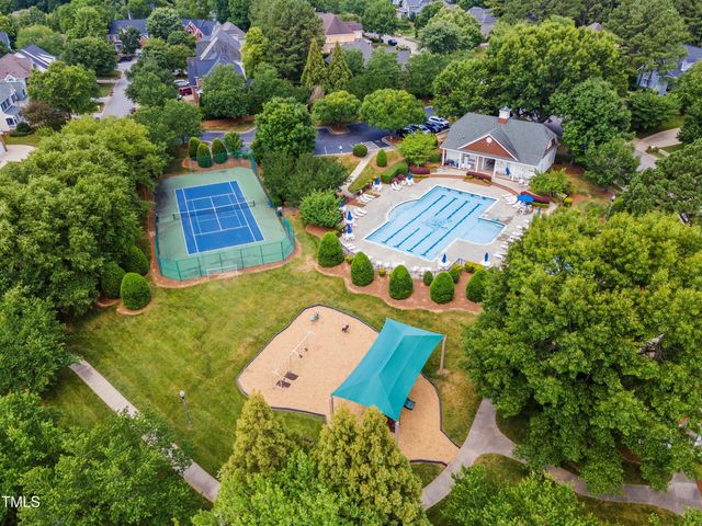 an aerial view of a house with a yard basket ball court and outdoor seating