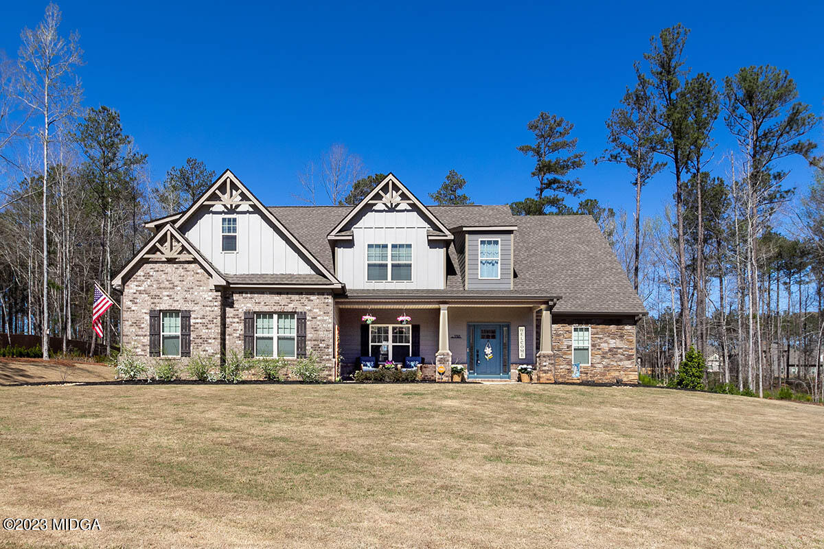 150 Homestead Circle Forsyth, GA 31029 - Photo 1 of 30 a view of a white house with a large windows and palm trees