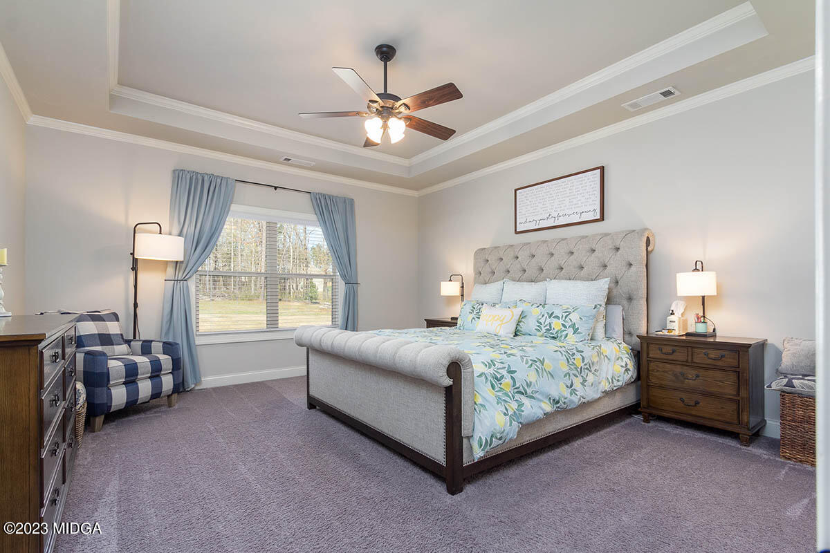 150 Homestead Circle Forsyth, GA 31029 - Photo 11 of 30 a bedroom with a bed couch and window