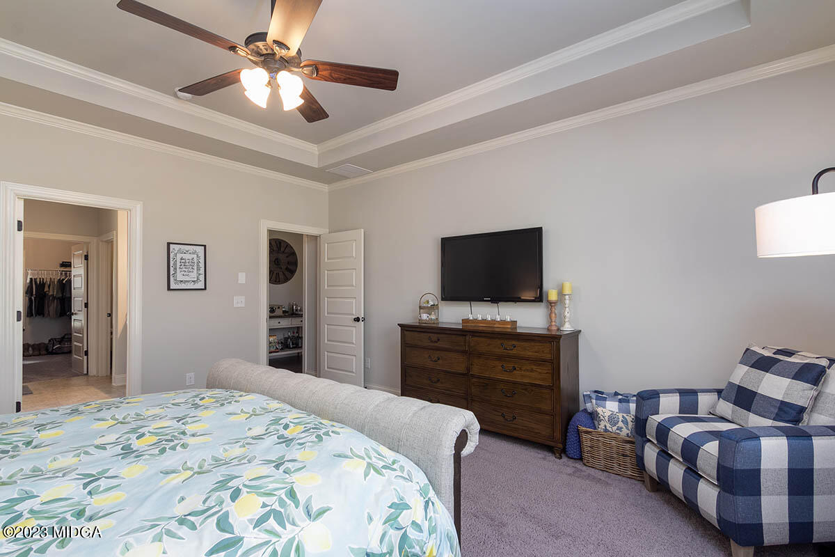 150 Homestead Circle Forsyth, GA 31029 - Photo 12 of 30 a bedroom with a bed and a flat screen tv