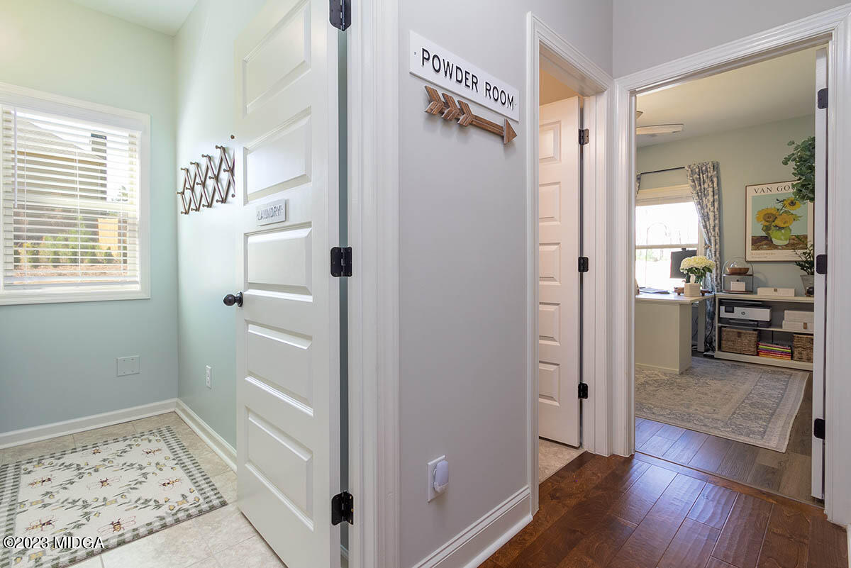 150 Homestead Circle Forsyth, GA 31029 - Photo 15 of 30 a view of a hallway with wooden floor and a bathroom