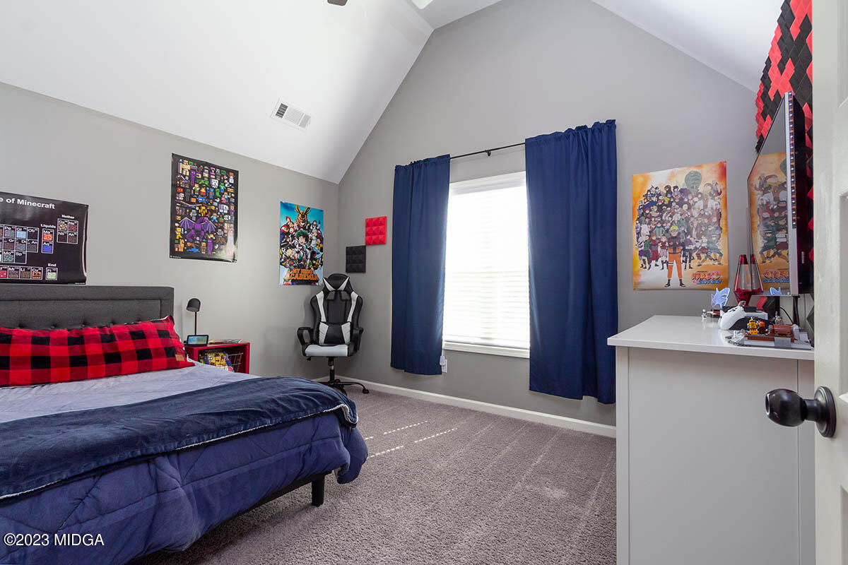 150 Homestead Circle Forsyth, GA 31029 - Photo 19 of 30 a bedroom with a bed and a window