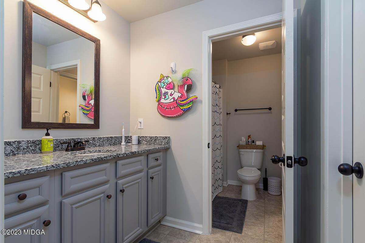 150 Homestead Circle Forsyth, GA 31029 - Photo 24 of 30 a bathroom with a sink a vanity and a mirror