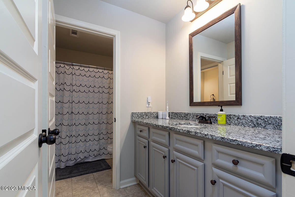 150 Homestead Circle Forsyth, GA 31029 - Photo 25 of 30 a bathroom with a sink and a mirror