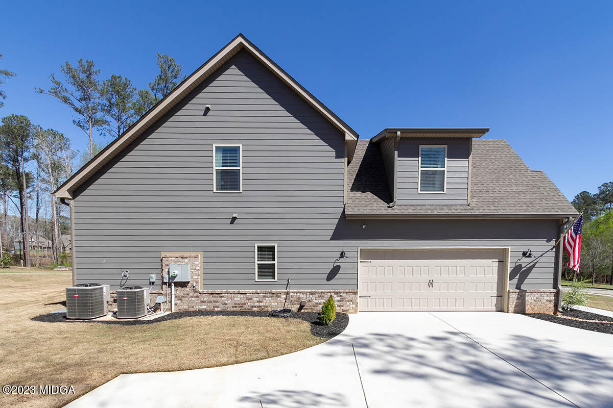150 Homestead Circle Forsyth, GA 31029 - Photo 26 of 30 a front view of a house with garage