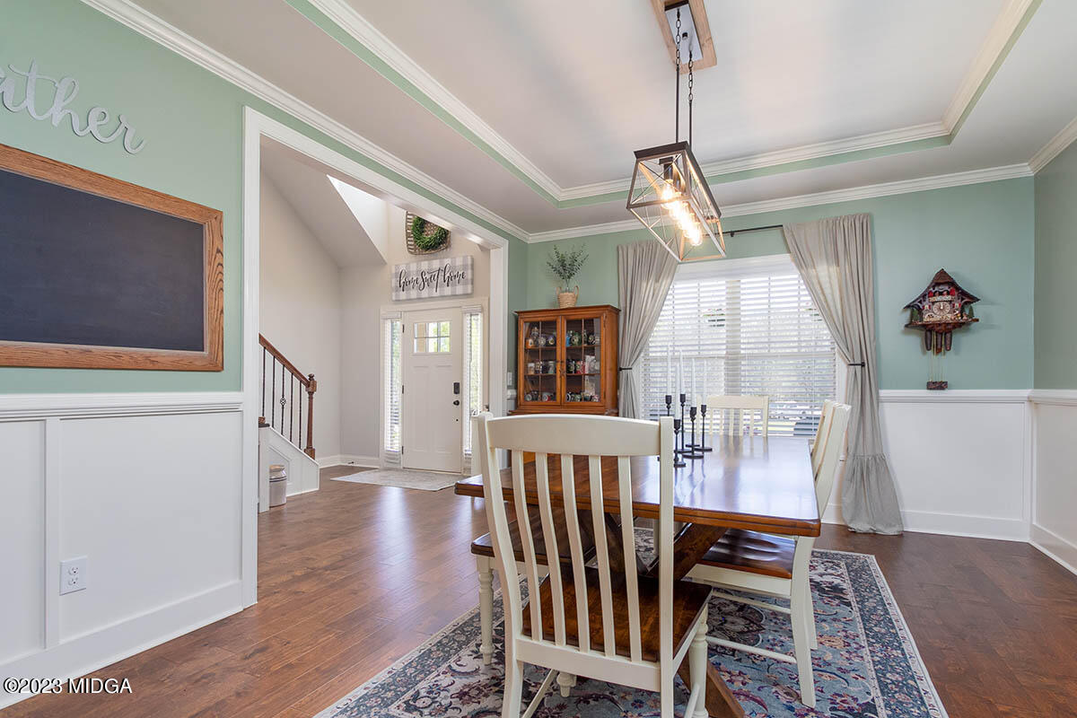 150 Homestead Circle Forsyth, GA 31029 - Photo 3 of 30 a view of a hallway with wooden floor and stairs