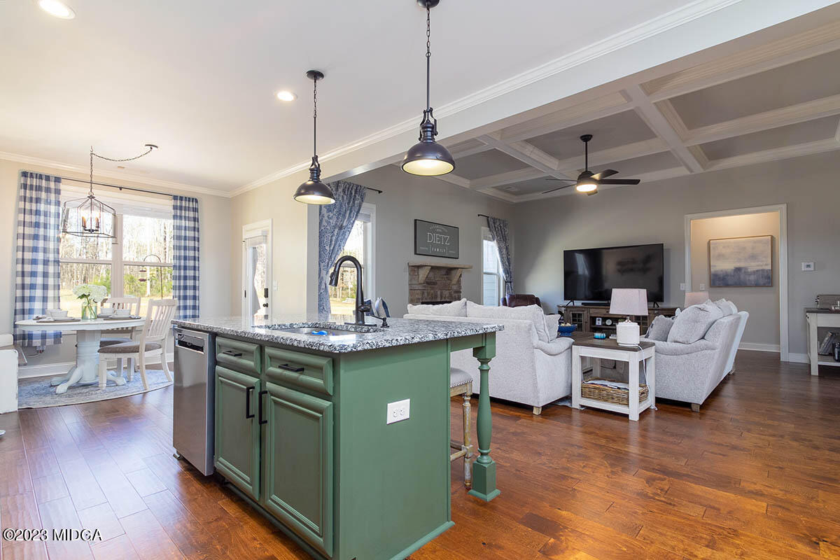 150 Homestead Circle Forsyth, GA 31029 - Photo 5 of 30 a view of a dining room and livingroom with furniture wooden floor a chandelier
