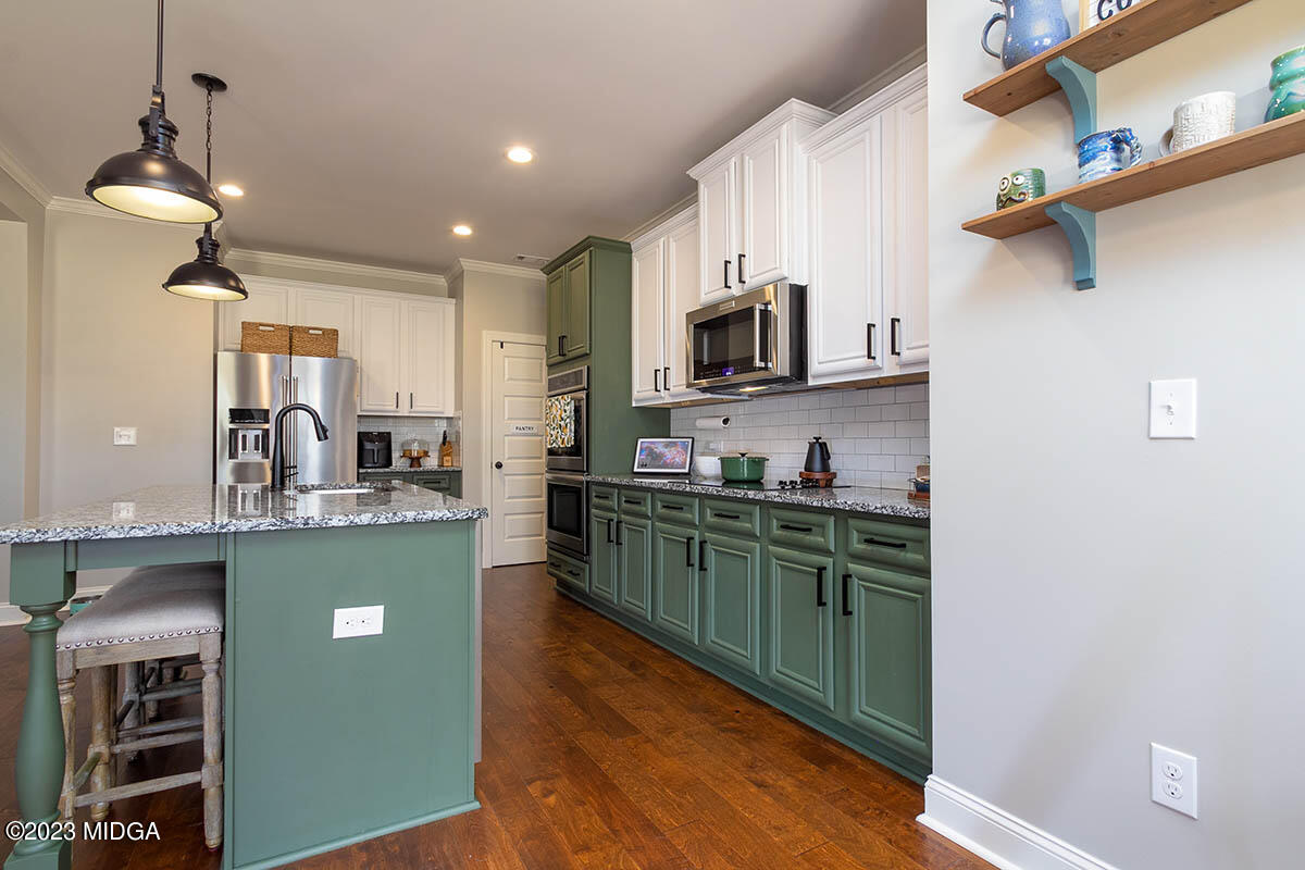 150 Homestead Circle Forsyth, GA 31029 - Photo 7 of 30 a kitchen with cabinets a sink and appliances