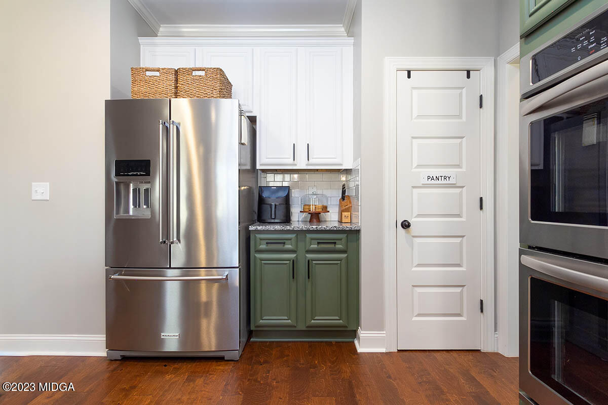 150 Homestead Circle Forsyth, GA 31029 - Photo 8 of 30 a kitchen with stainless steel appliances a refrigerator stove and microwave