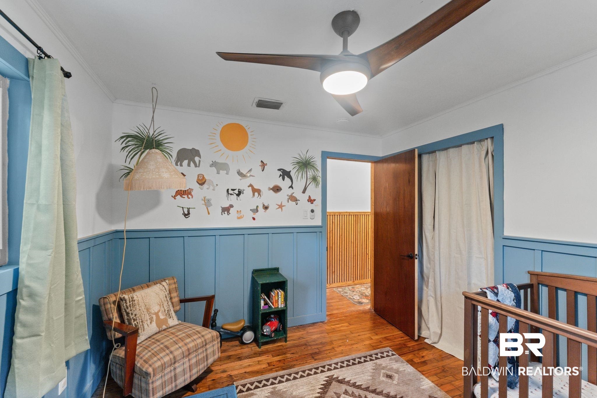 10785 Gregg Road Semmes, AL 36575 - Photo 18 of 35 Bedroom featuring wood-type flooring, crown molding, a crib, wainscoting, and ceiling fan