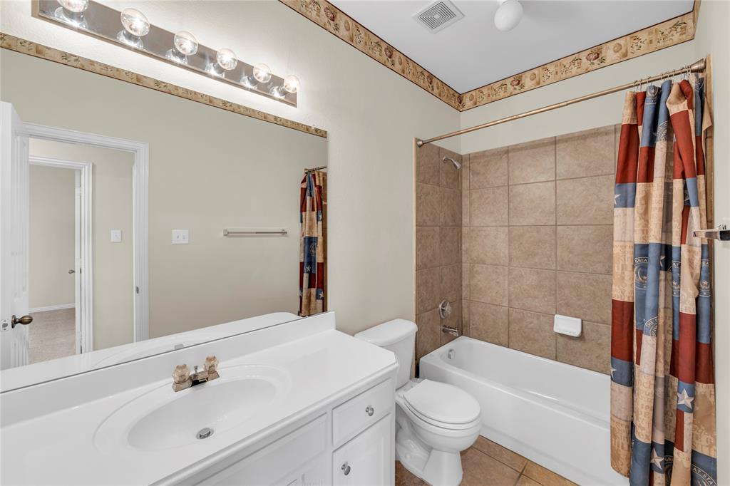 3920 Autumn Lane Bedford, TX 76021 - Photo 32 of 36 Bathroom featuring a single vanity with an integrated sink, a rectangular mirror, and a chrome light fixture