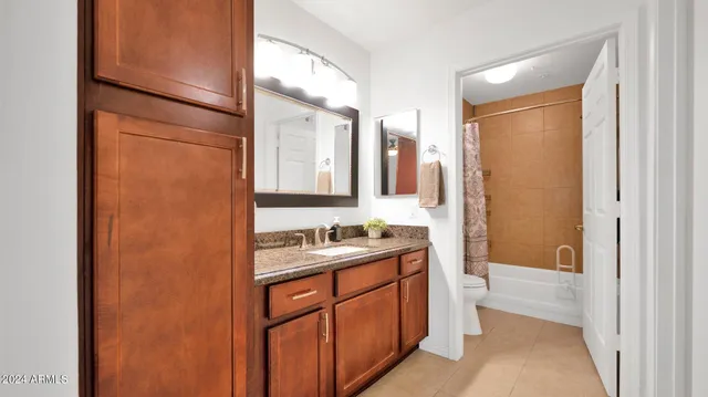a bathroom with a sink a mirror and a shower