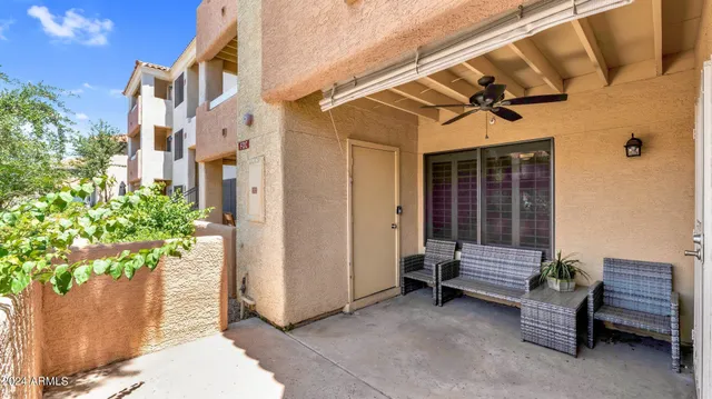 a view of a porch with a bench and potted plants