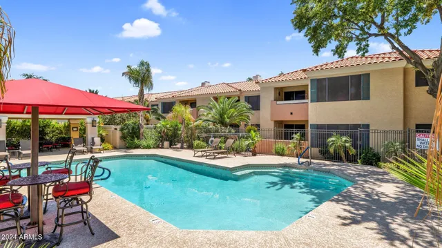 a view of a house with swimming pool and sitting area