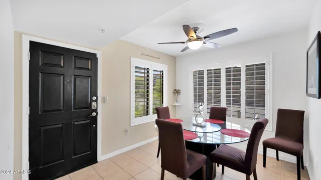 a dining room with furniture window and wooden floor
