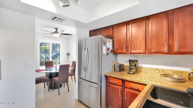 a kitchen with stainless steel appliances granite countertop a refrigerator and a sink