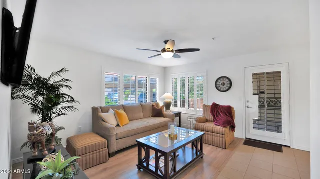 a living room with furniture a chandelier and a window