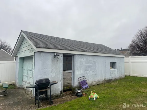 a backyard of a house with table and chairs
