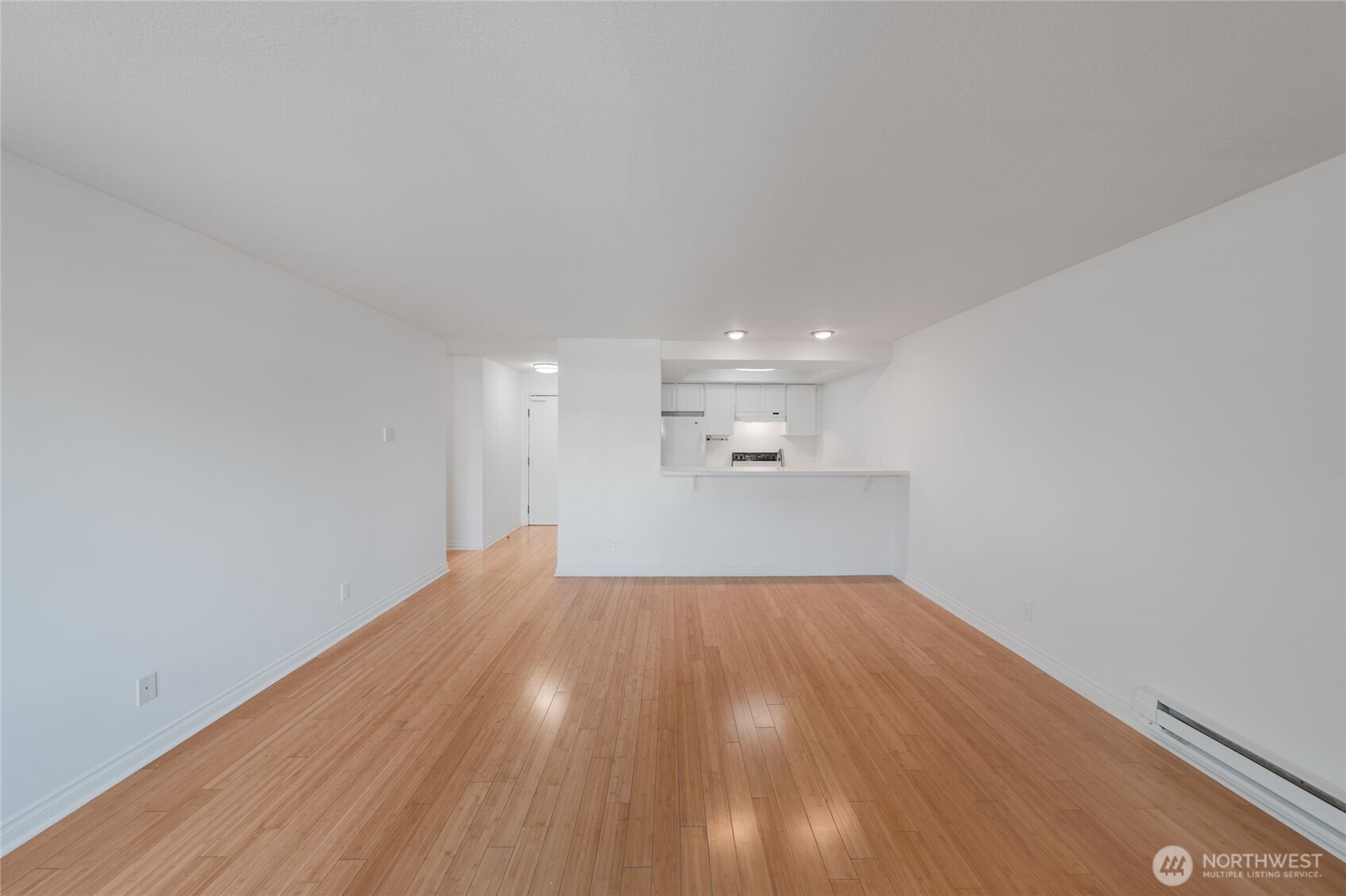 6055 35th Avenue Southwest, Unit 308 Seattle, WA 98126 - Photo 17 of 39 a view of empty room with wooden floor