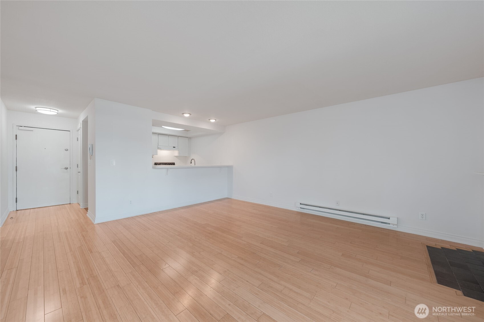 6055 35th Avenue Southwest, Unit 308 Seattle, WA 98126 - Photo 21 of 39 a view of empty room with wooden floor