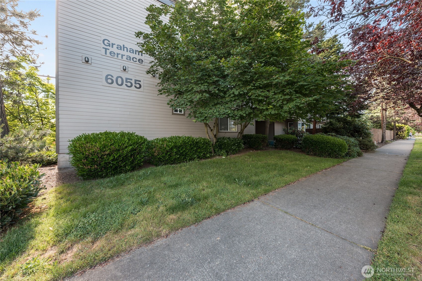 6055 35th Avenue Southwest, Unit 308 Seattle, WA 98126 - Photo 33 of 39 a view of a backyard with green space