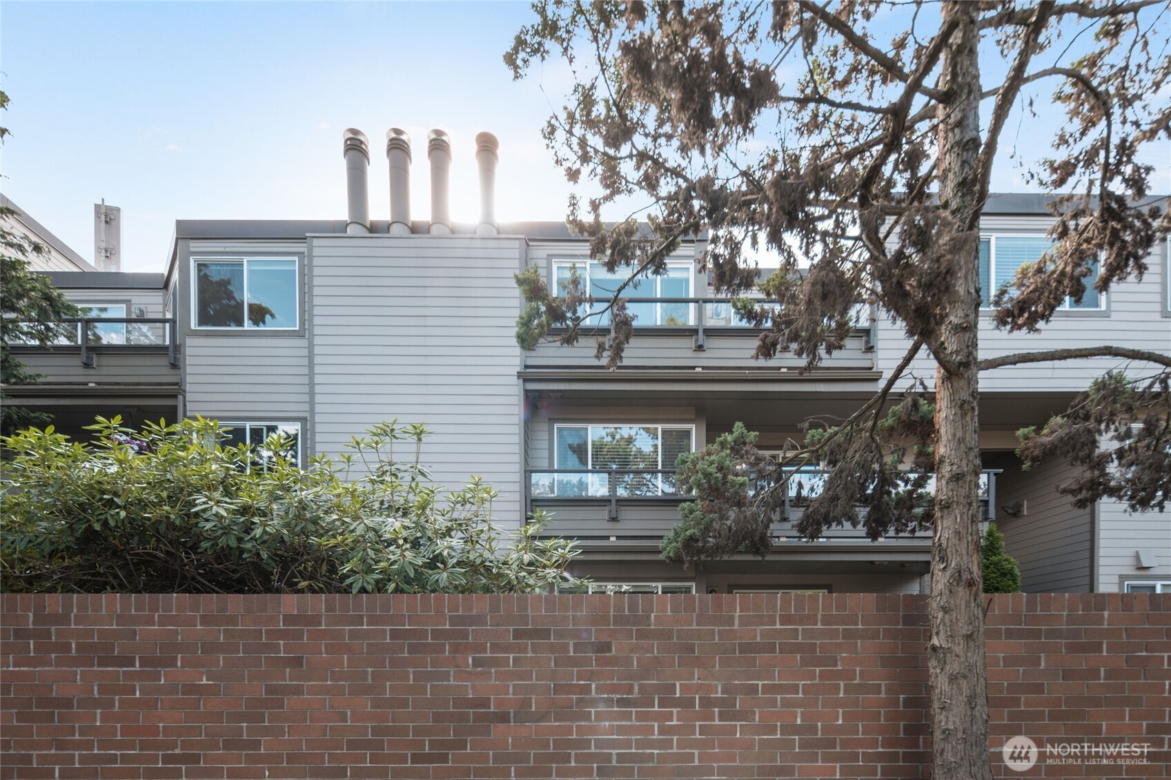 6055 35th Avenue Southwest, Unit 308 Seattle, WA 98126 - Photo 34 of 39 a front view of a house with garden