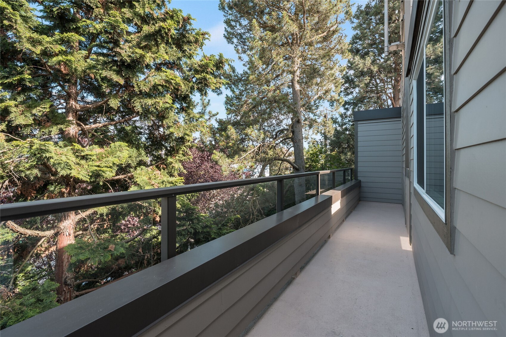 6055 35th Avenue Southwest, Unit 308 Seattle, WA 98126 - Photo 5 of 39 a view of a balcony with wooden floor and fence