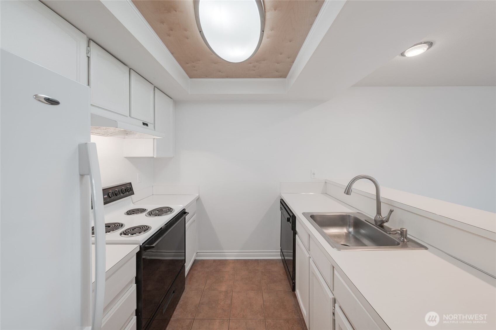 6055 35th Avenue Southwest, Unit 308 Seattle, WA 98126 - Photo 9 of 39 a kitchen with stainless steel appliances a sink a stove and a refrigerator