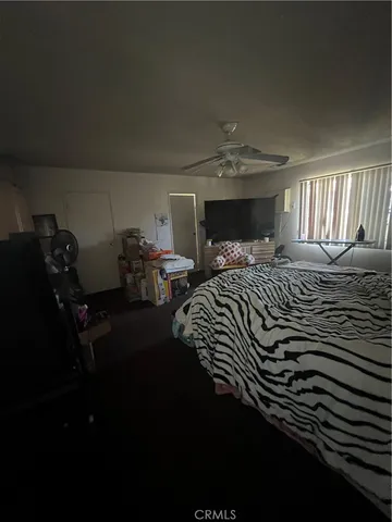 a bedroom with two beds and a lamp