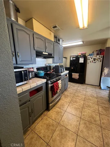 a kitchen with stainless steel appliances a sink stove and cabinets