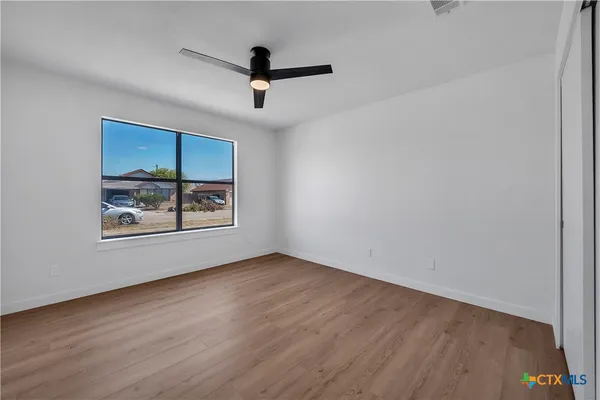 wooden floor in an empty room with a window