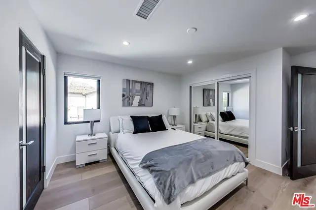 a bedroom with a large bed and a couch